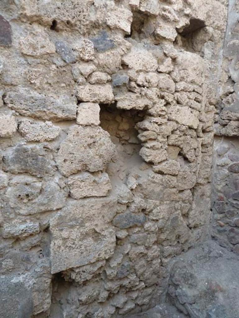 V.2.13 Pompeii. September 2015. West wall above hearth, in north-west corner of kitchen.