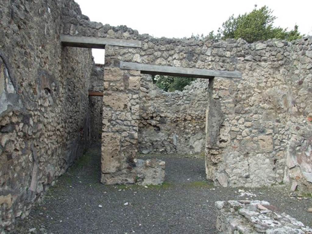 V.2.13 Pompeii,  March 2009. North wall, with corridor to kitchen and latrine and doorway to rear room.