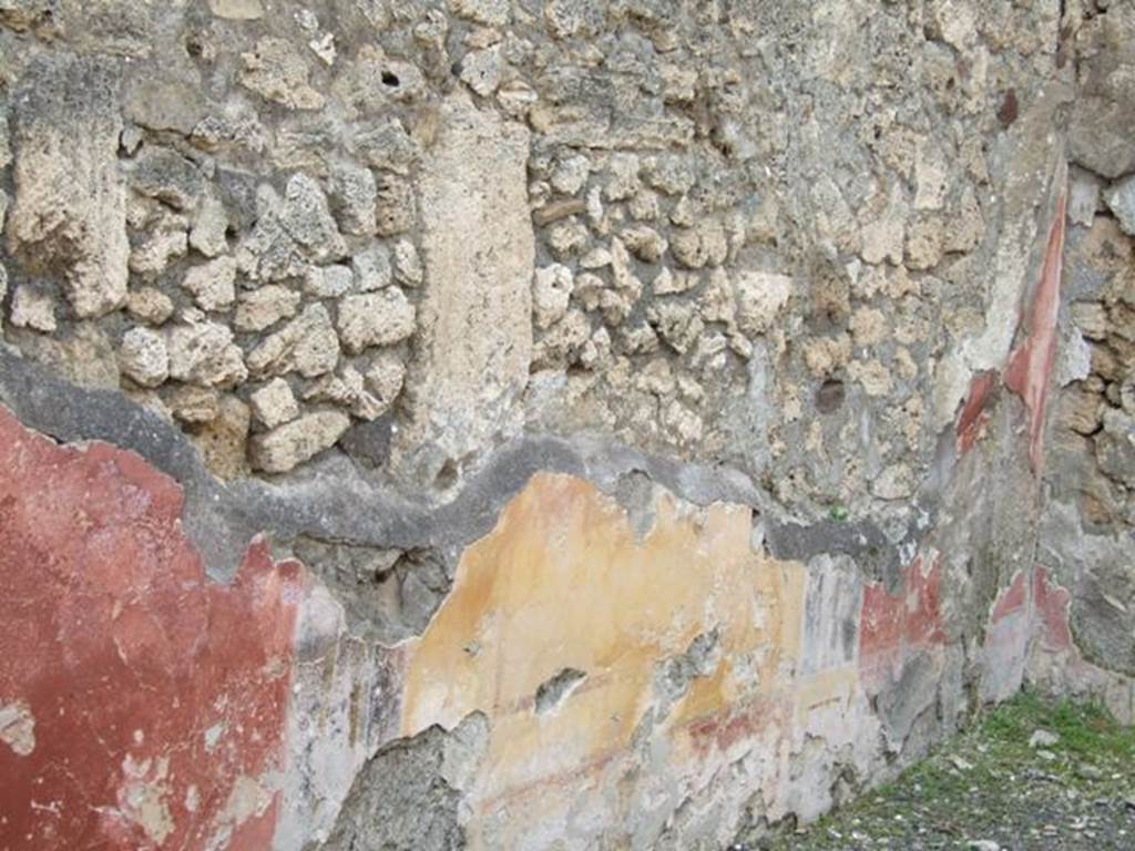 V.2.14 Pompeii. March 2009. West wall of rear room with remains of yellow central panel, and the two red side panels.
