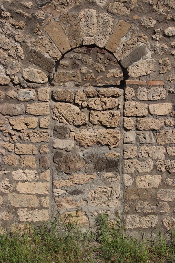 V.3.3 Pompeii. October 2023. 
East wall of shop-room with blocked arched doorway to fauces of V.3.4. Photo courtesy of Klaus Heese.
