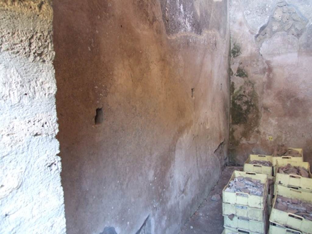 V.3.4 Pompeii. March 2009.  Small room, East wall with remains of shelving supports.