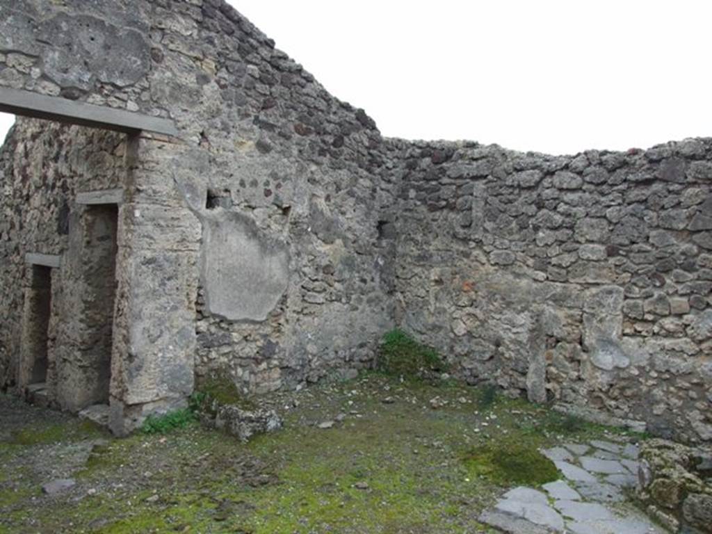 V.3.8 Pompeii.  December 2007.  South west corner of the Atrium bakery area.  Against the south wall are the masonry remains of two possible table supports. 