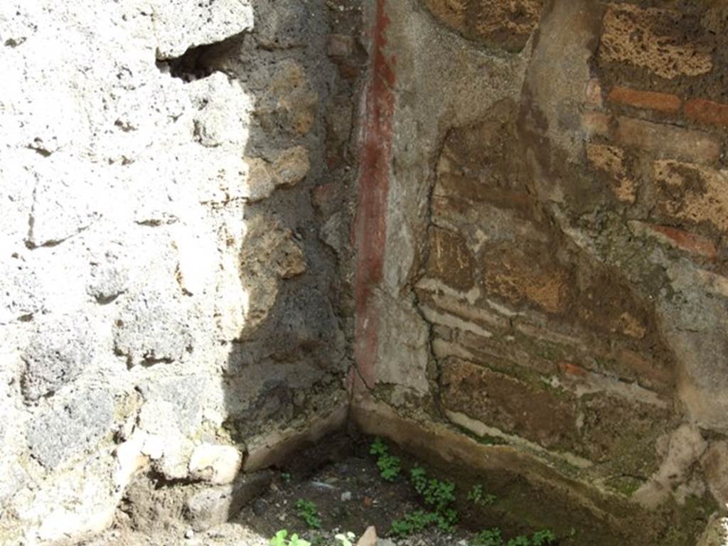 V.5.4 Pompeii.  March 2009. Remains of plaster in south east corner of shop.