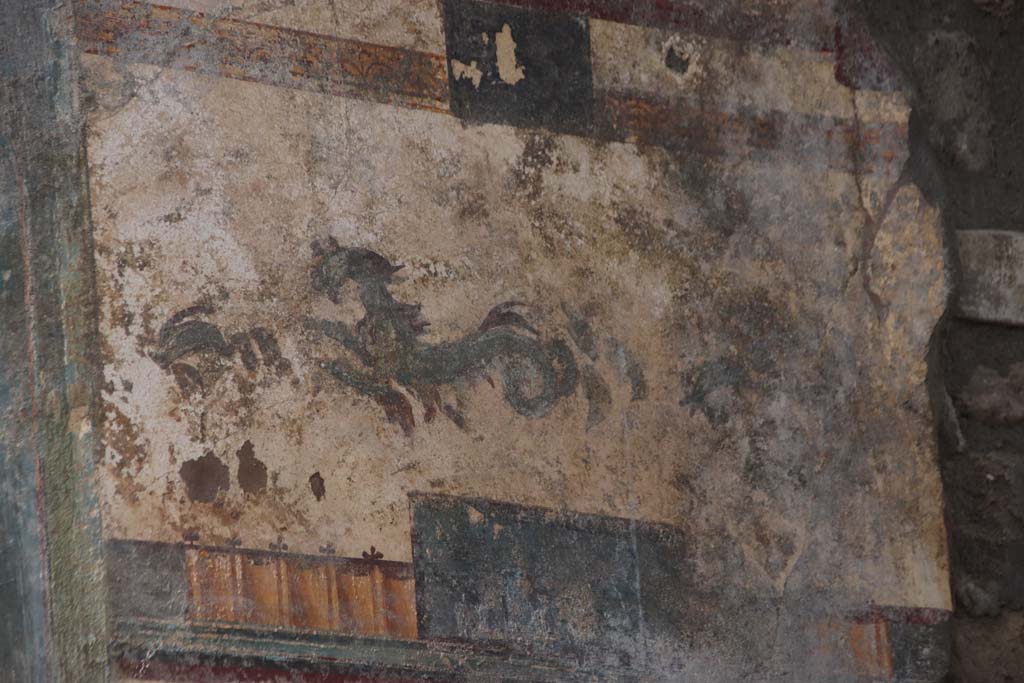 V.6.12 Pompeii. October 2020. Detail of dolphin and marine animal from upper panel on east side of central painting of Priapus.
Photo courtesy of Klaus Heese.

