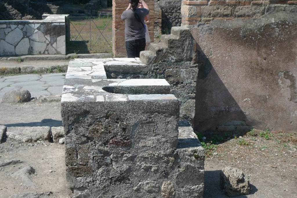 VI.1.5 Pompeii. July 2010. Looking west across counter, and area of hearth in counter. Photo courtesy of Michael Binns.