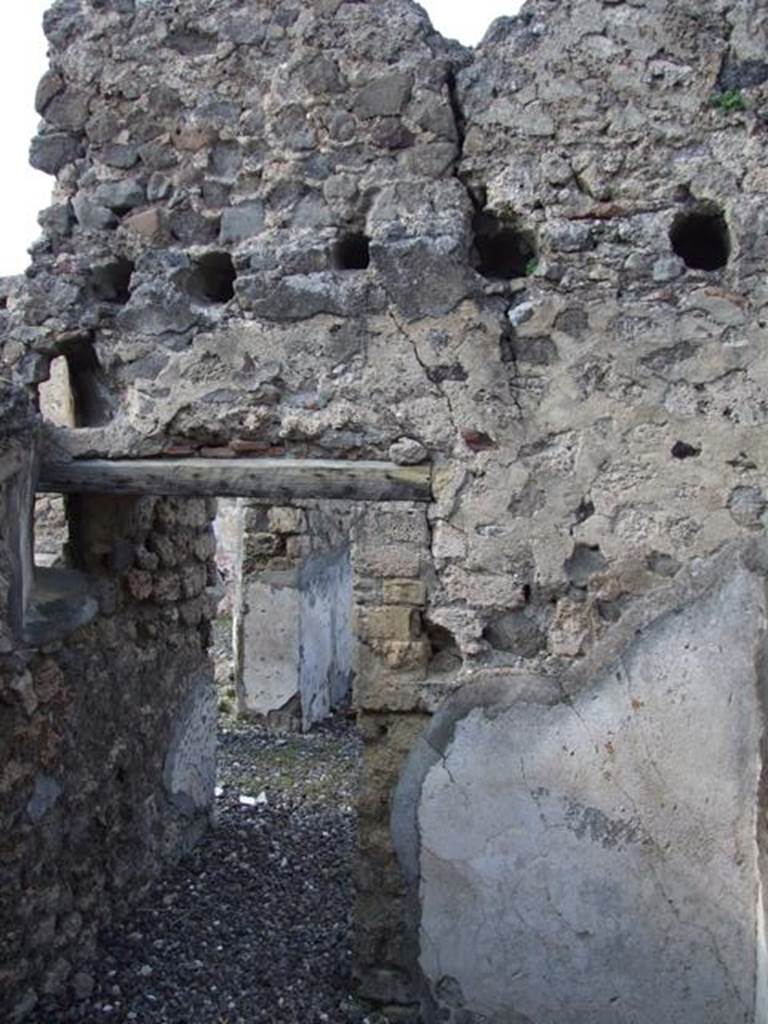 VI.7.1 Pompeii. March 2009. North wall of small room or storeroom with door. According to Fiorelli, the walls of this small room were used to keep accounts graffiti written with the stylus. There were also two vents to make the room better ventilated.
See Pappalardo, U., 2001. La Descrizione di Pompei per Giuseppe Fiorelli (1875). Napoli: Massa Editore. (p.57)
