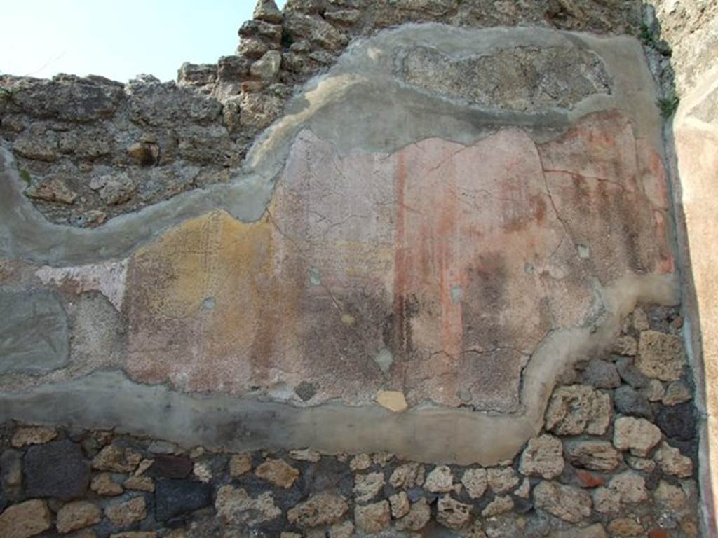 VI.7.6 Pompeii. March 2009. Room 10, east end of north wall of triclinium, with remains of painted plaster.