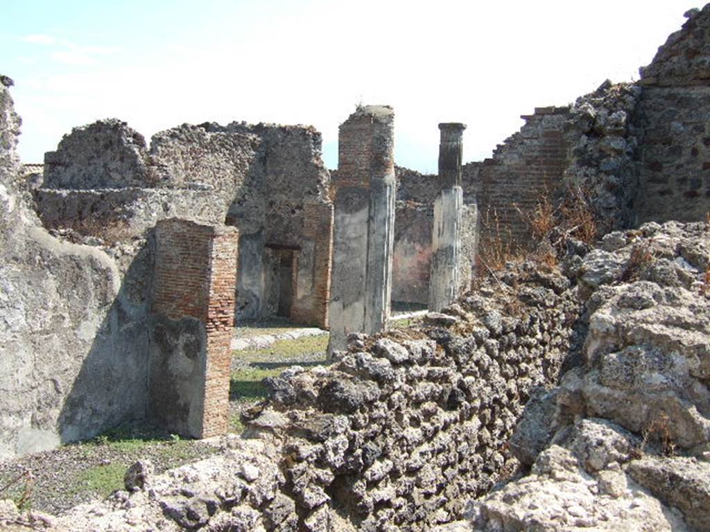 VI.7.20 Pompeii, September 2005. Looking south-east across triclinium towards peristyle.
On the left would be the east wall of the triclinium. Between the walls, in the lower right, would be east wall of the corridor leading to the kitchen and latrine. In the centre, between the pilasters, the south wall of the small room with the painted medallions can be seen, with doorway into corridor between atrium and peristyle.  Taken over wall in Vicolo della Fullonica.

