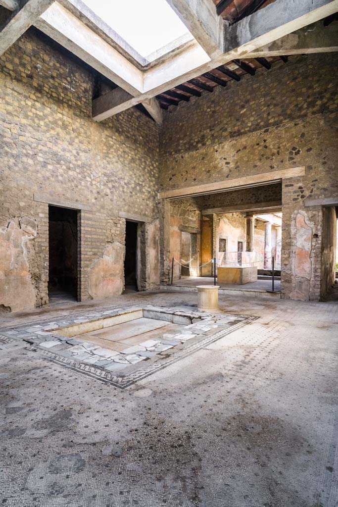 VI.8.3/5 Pompeii. April 2022. 
Looking north-west across impluvium towards rooms on west side of atrium and tablinum. 
Photo courtesy of Johannes Eber.
