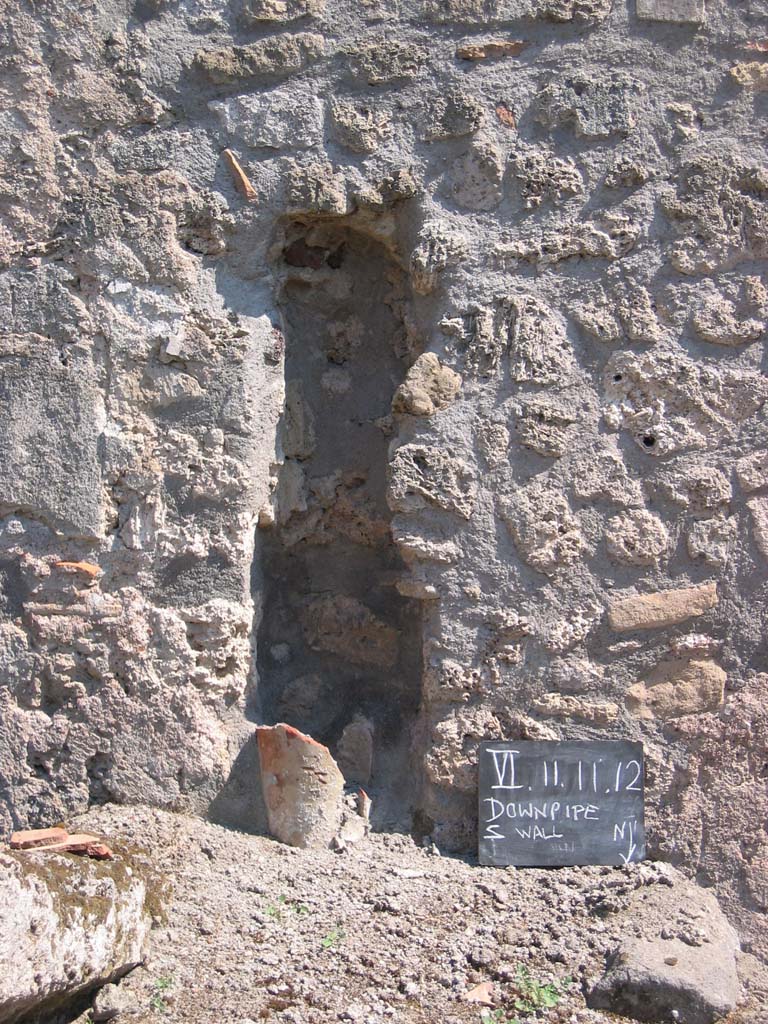 VI.11.11 Pompeii. July 2008. Downpipe in south wall. Photo courtesy of Barry Hobson.