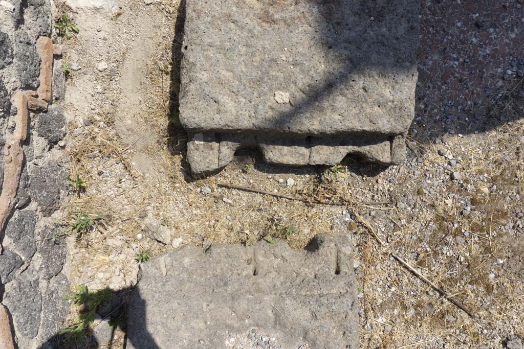 VI.12.5 Pompeii. 14th July 2017. Remains of base near north wall in north-west corner of Secondary Atrium 7, looking east.
According to Pernice, this base of a money chest is made of tuff. It is narrower in the middle and has two holes in it. 
It must have broken in ancient times because it was reassembled with two dovetail clamps that no longer exist.
See Pernice, E., 1932. Hellenistische Tische, Zisternenmündungen, Beckenuntersätze, Altäre u. Truhen. Berlin, p. 74, Taf. 44.4.
Foto Annette Haug, ERC Grant 681269 DÉCOR.

