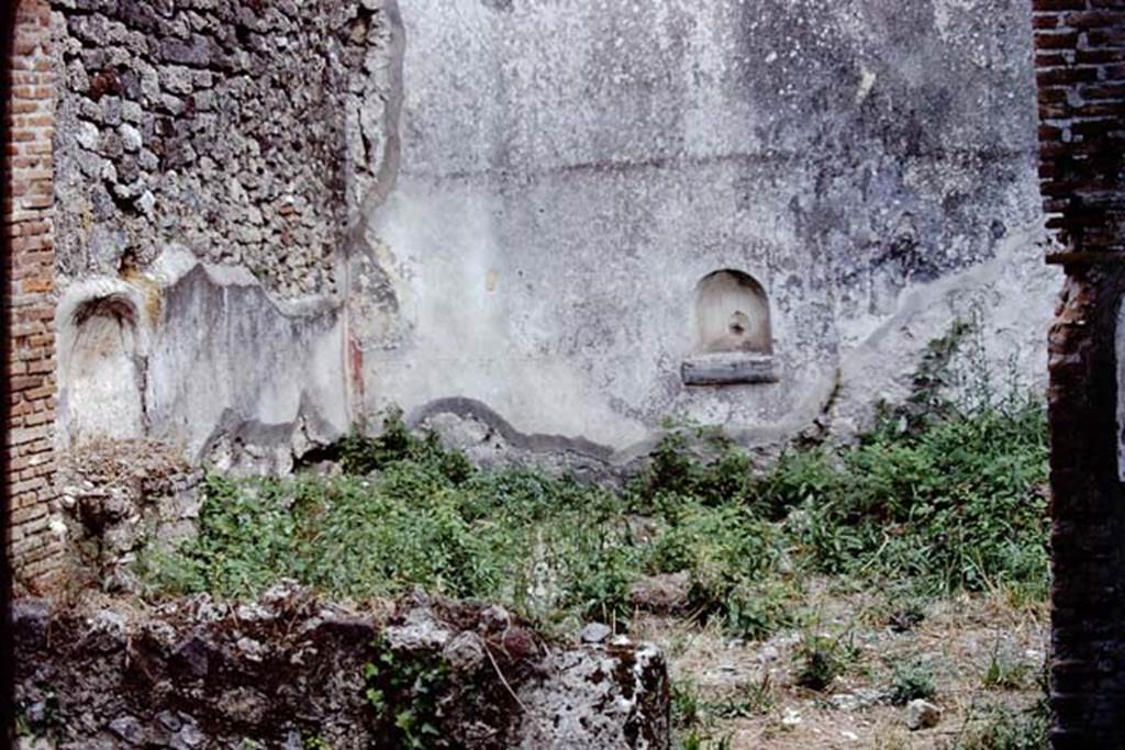 VI.14.30 Pompeii. 1972. Looking towards south-east corner of garden area. 
The remains of the aedicula lararium can be seen against the east wall, on the left, and the niche against the south wall, centre right.
According to PPM, the garden wall decoration is now completely lost but was accurately described by Mau.
See Mau, in Bullettino dell’Instituto di Corrispondenza Archeologica (DAIR), 1876, pp.53-54.
See Carratelli, G. P., 1990-2003. Pompei: Pitture e Mosaici. Vol. V. Roma: Istituto della enciclopedia italiana. (p.358, nos.24-25)
Photo by Stanley A. Jashemski. 
Source: The Wilhelmina and Stanley A. Jashemski archive in the University of Maryland Library, Special Collections (See collection page) and made available under the Creative Commons Attribution-Non-Commercial License v.4. See Licence and use details.
J72f0410

