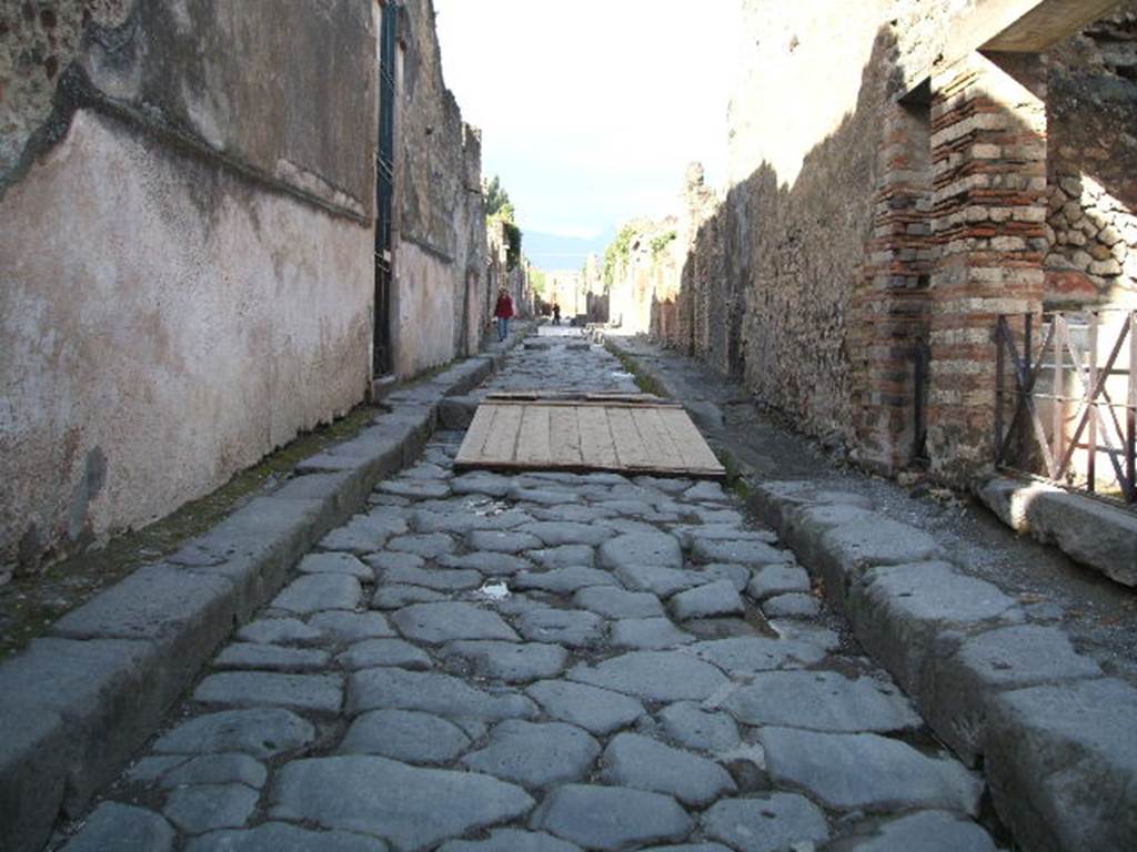 VI.15.1 Pompeii. Vicolo dei Vettii from Vicolo di Mercurio looking north.  VI.16.  According to Della Corte, found inside the house were two seal/signets and one bronze finger ring, these read –
A. Vetti
Restituti      or A. Vettius Restitutus   [see S.100]
A.V.CO        or A. V(ettius) Co(nviva)  [see S.99]
A. Vetti
Convivaes  or A. Vettius Convia         [see S.98]
Combined with graffiti found on the south corner of the insula, these proved to Della Corte that this was the house built by two rich merchants Aulus Vettius Restitutus and Aulus Vettius Conviva. Although this house illustrated the luxury of the commercial classes during the last decades of the city’s life, nothing was revealed of how these two made their money or their business. These graffiti were CIL IV 3522 and 3509.  
Also found on the same wall were CIL IV 3506, 3507 and 3521.
See Della Corte, M., 1965.  Case ed Abitanti di Pompei. Napoli: Fausto Fiorentino.(p.67-71)
According to Epigraphik-Datenbank Clauss/Slaby (See www.manfredclauss.de), these read -
[[3]] Sabinum aed(ilem) 
[[3]] Restitutus rog(at)       [CIL IV 3522]
Vetti Con[vi]va Augustali[s]       [CIL IV 3509]  
Appuleium IIvir(um)            [CIL IV 3506]
Liberalis       [CIL IV 3507]
A(ulum) Trebium Valentem aed(ilem) o(ro) v(os) f(aciatis) Hilarus rog(at)       [CIL IV 3521]
