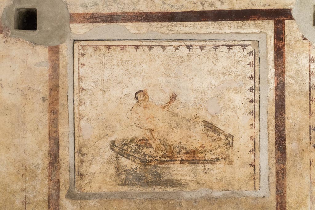 VI.15.1 Pompeii. October 2023. 
Erotic painting on east wall in bedroom (x’), used either by servants or as a private brothel? Photo courtesy of Klaus Heese.
