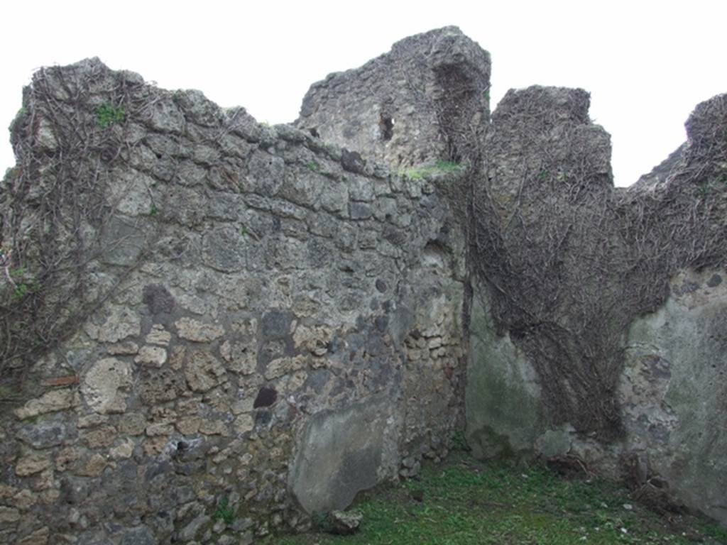 VI.16.27 Pompeii. March 2009. Room T, south-west corner. According to NdS, leaning against the south wall near the entrance doorway, on left of photo, would have been a small hearth.
