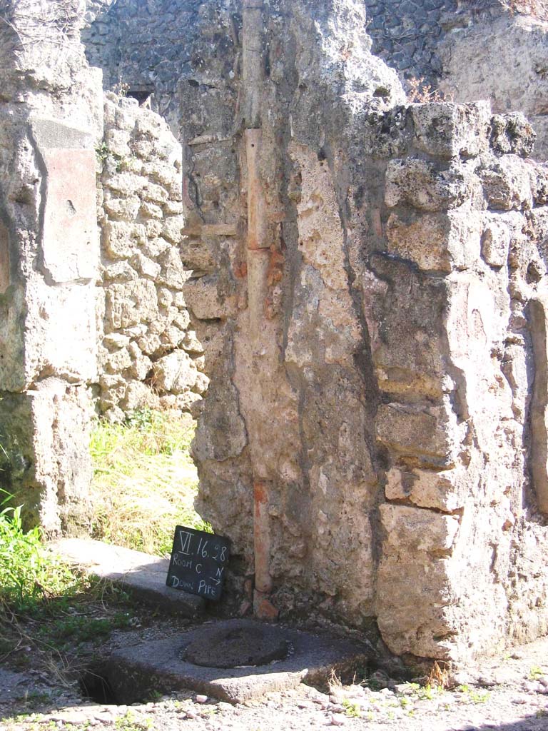 VI.16.28 Pompeii. July 2008. 
Looking south-west in room C towards pilaster between rooms D and A. Photo courtesy of Barry Hobson.
According to Hobson, occasionally narrow bore pipes might bring the rainwater directly off the roof directly into the cistern.
See Hobson, B., 2009. Latrinae et foricae: Toilets in the Roman World. London; Duckworth. (p.117, and fig 119)
According to Hobson, this pipe had an external diameter of 10cm, whereas the other two found from upper floors had a diameter of 18cm.
See Hobson, B. 2009. Pompeii, Latrines and Down Pipes. Oxford, Hadrian Books, (p.290 and p.295)
