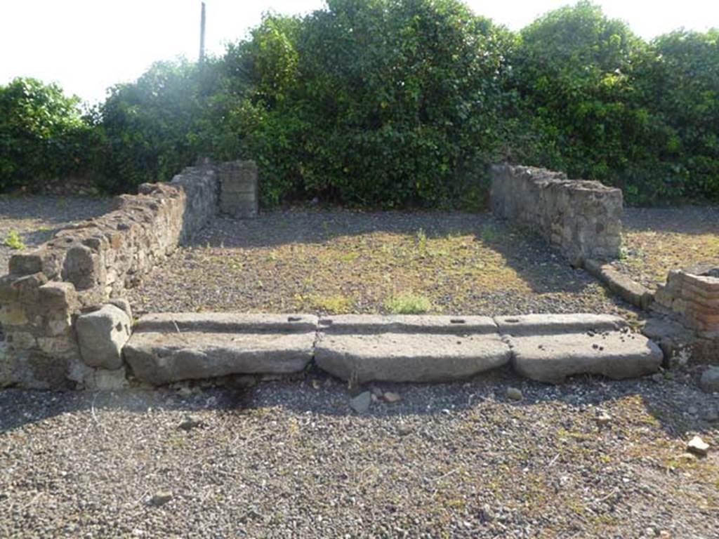 VI.17.4 Pompeii. May 2011. Looking west into second room on west side at rear of bar, with lava threshold.