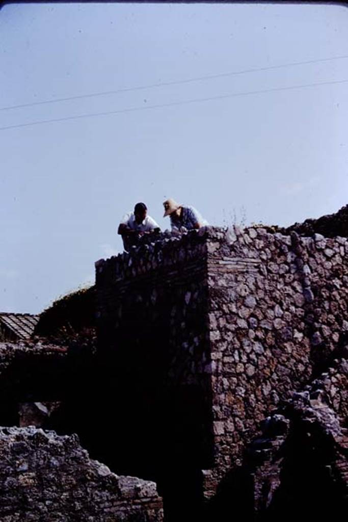 VII.1.36 Pompeii. 1966. Studying the top of the oven. Photo by Stanley A. Jashemski.
Source: The Wilhelmina and Stanley A. Jashemski archive in the University of Maryland Library, Special Collections (See collection page) and made available under the Creative Commons Attribution-Non Commercial License v.4. See Licence and use details.
J66f0647
