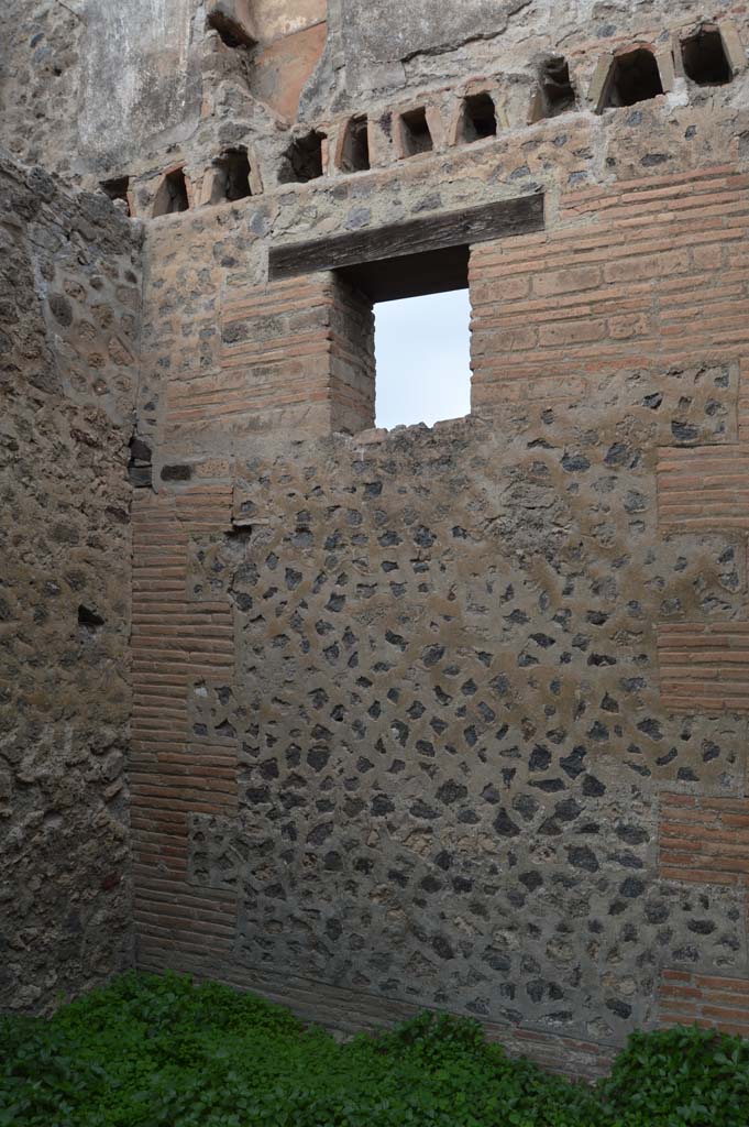 VII.2.18 Pompeii.  March 2009. Room 9, upper floor apartment, latrine in north wall of upper floor. According to Hobson, a total of 15 upper storey latrines have been identified in the city, including this one. He says that these latrines would seem to have been placed near to the top of the staircase, and would have been placed in narrow plastered niches with terracotta downpipes inserted into the walls to carry the waste product down into the cesspit.  This latrine shows the slots in the sides of the niche where the wooden seat fitted, and the tapering, easily sluiced plaster below the seat.
See Hobson, B., 2009. Latrinae et foricae: Toilets in the Roman World. London; Duckworth. (p.75-6).
