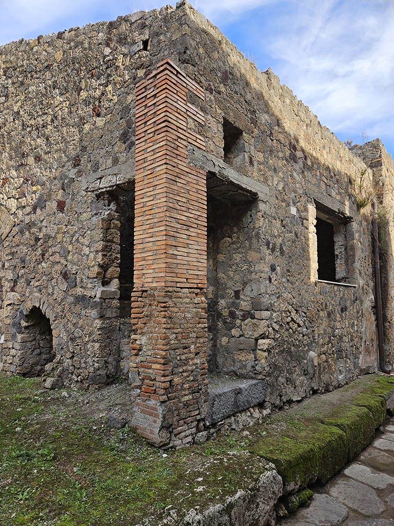 VII.3.27 Pompeii. November 2024. 
Looking east from VII.3.28 along front façade, with doorway to steps at VII.3.27, and window at VII.3.26.
Photo courtesy of Annette Haug.
