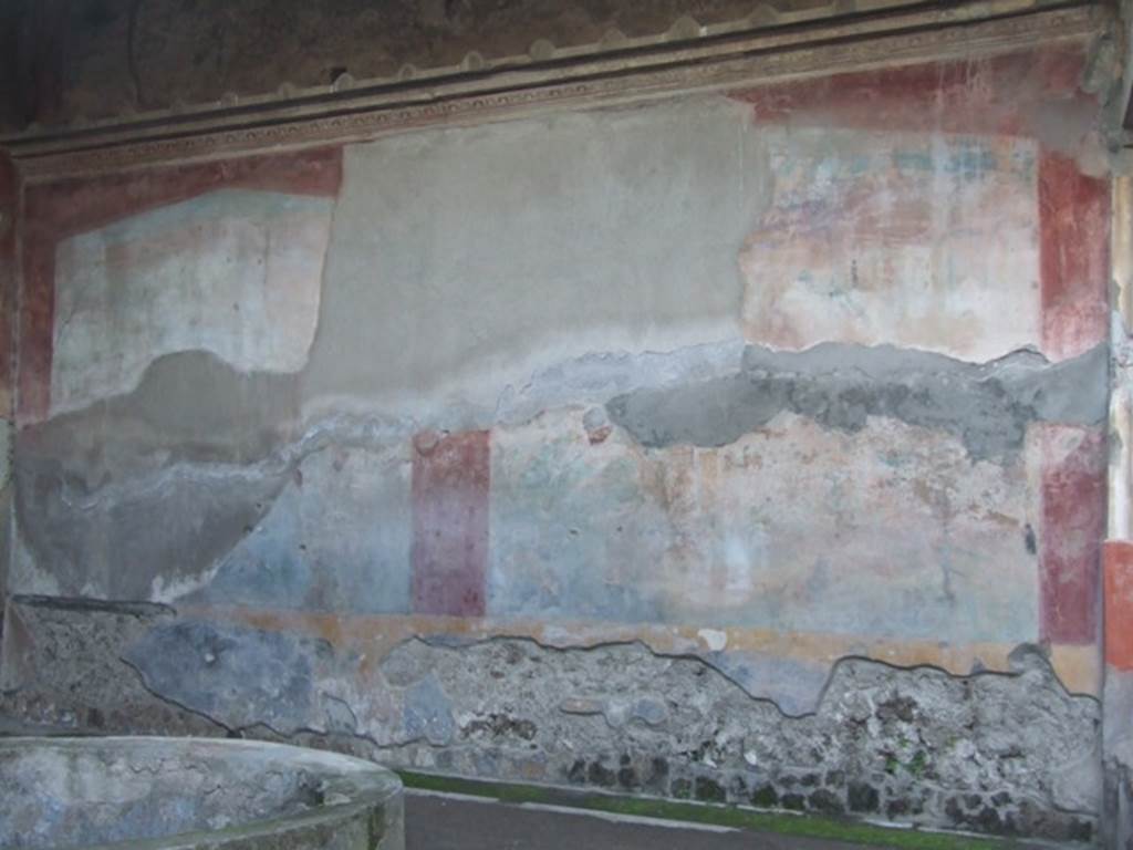 VII.4.48 Pompeii. December 2007. Peristyle, west wall. Due to the explosion of a bomb which fell in 1943, the west wall suffered from the destruction and the partial fall of the plaster from the large painting. The figure of Galatea in the centre of the lower zone was definitely destroyed.
See Garcia y Garcia, L., 2006. Danni di guerra a Pompei. Rome: LErma di Bretschneider. (p.98, fig 218)
