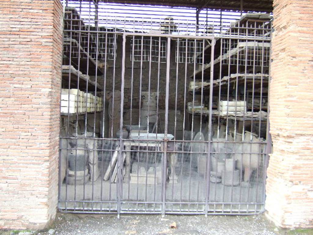 VII.7.29 Pompeii. May 2006. Looking west through entrance doorway towards items in storage.

