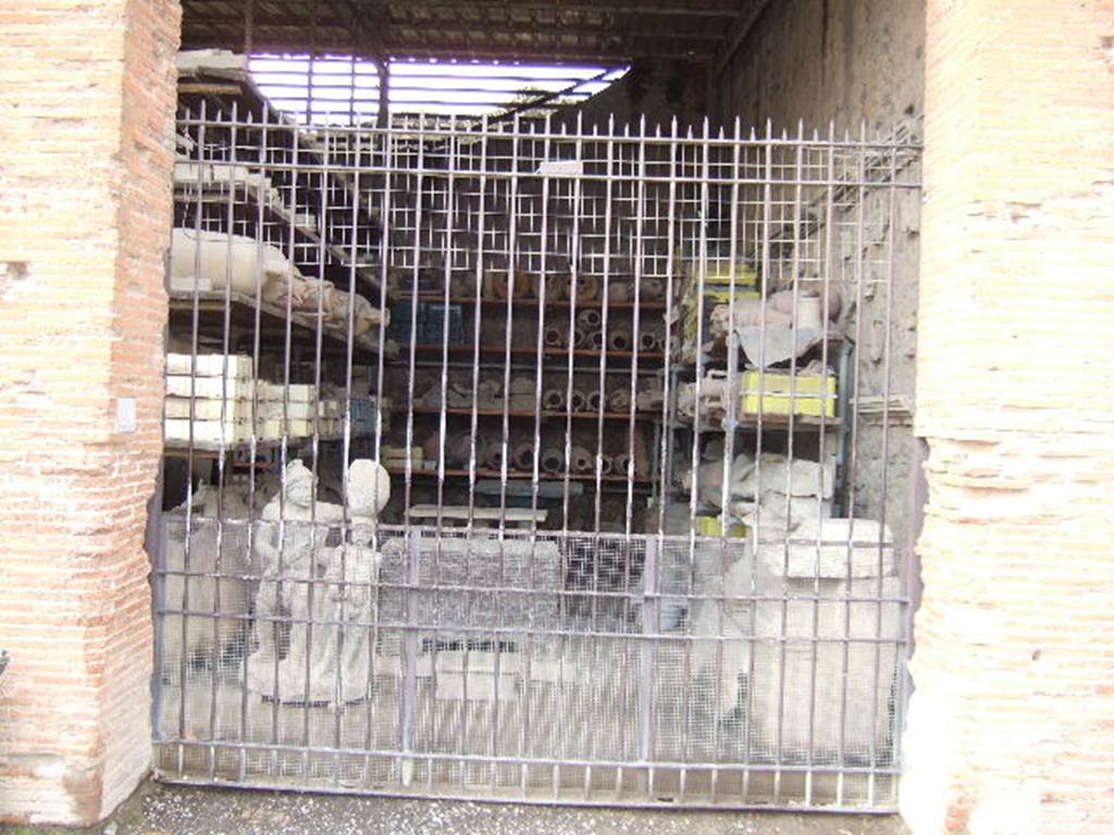 VII.7.29 Pompeii. May 2006. Looking west through entrance doorway towards items in storage.