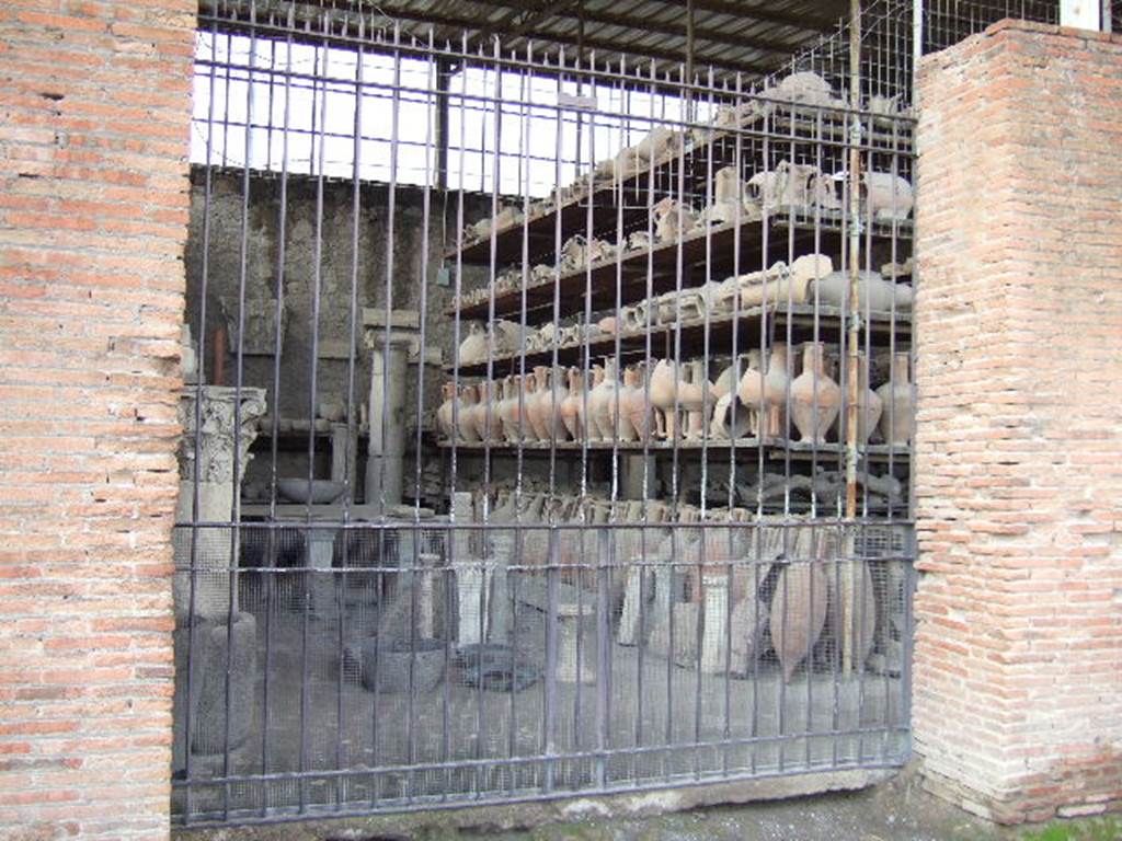 VII.7.29 Pompeii. May 2006. Looking west through entrance doorway towards items in storage.