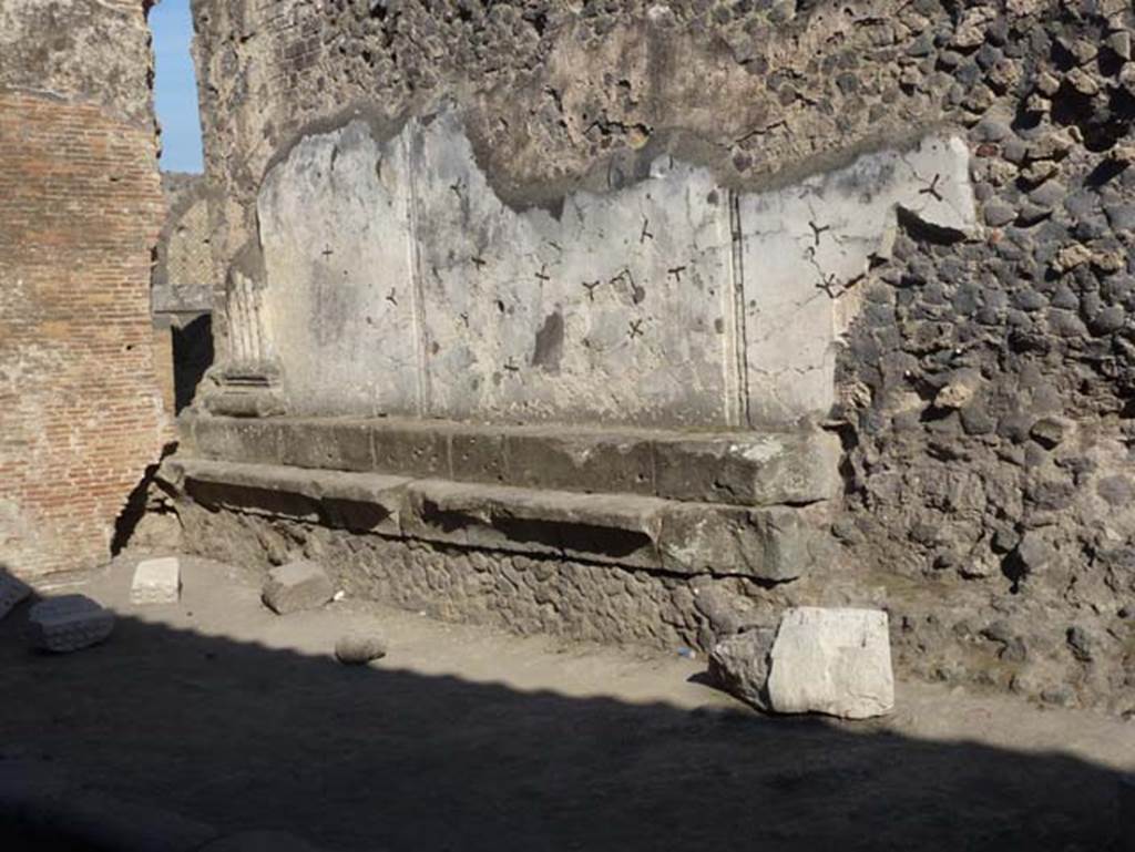 VII.8.1 Pompeii. June 2012. Looking towards remains of decoration on the rear of the north wall of Temple of Jupiter, at the east end. Photo courtesy of Michael Binns.
