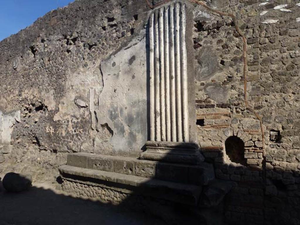 VII.8.1 Pompeii. June 2012. Looking towards remains of decoration on the rear of the north wall of Temple of Jupiter.Photo courtesy of Michael Binns.
