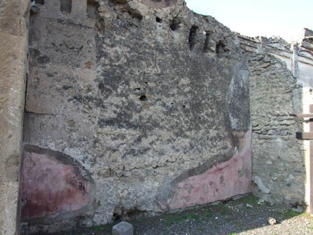 VII.13.1 Pompeii. December 2007. West wall of shop-room with remains of painted plaster.