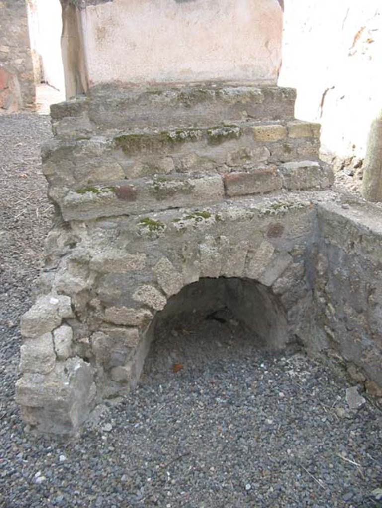 VII.15.5 Pompeii. May 2003. Looking north towards display shelving at end of counter, with recess below. 
Photo courtesy of Nicolas Monteix.
