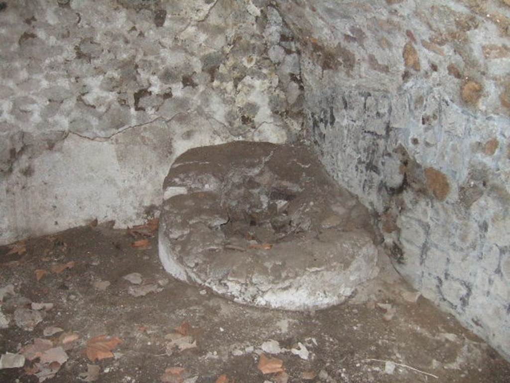 VII.15.16 Pompeii. May 2006. Open space (I), south-east corner with circular masonry base.   
According to Franklin, in the centre of the masonry base was a small basin.   
See Franklin, J.L. (Jnr) 1990. Pompeii, the Casa del Marinaio and its history. SAP, monograph 3. Roma; LERMA di Bretschnieder, (p.36).
