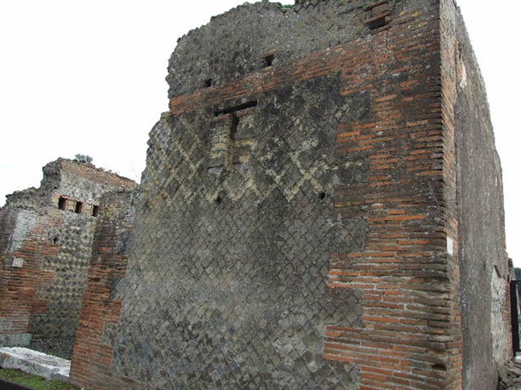 VIII.2.30 Pompeii. December 2006. Looking east to detail of front wall on east side of entrance doorway, on right.