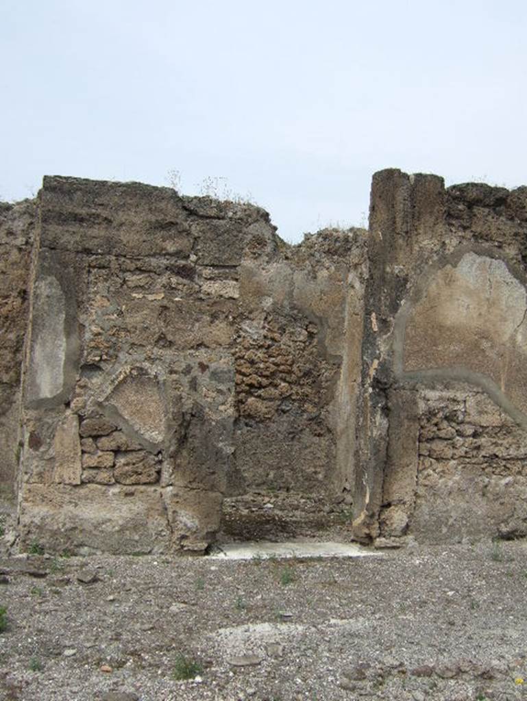 VIII.2.34 Pompeii. May 2006. Looking north-west through doorway of cubiculum k on west side of atrium c. The flooring found in this room was of cocciopesto with a net of meandering swastikas, alternating with squares with a white central cross. When excavated, only a fragment of black zoccolo was found on the east wall.
