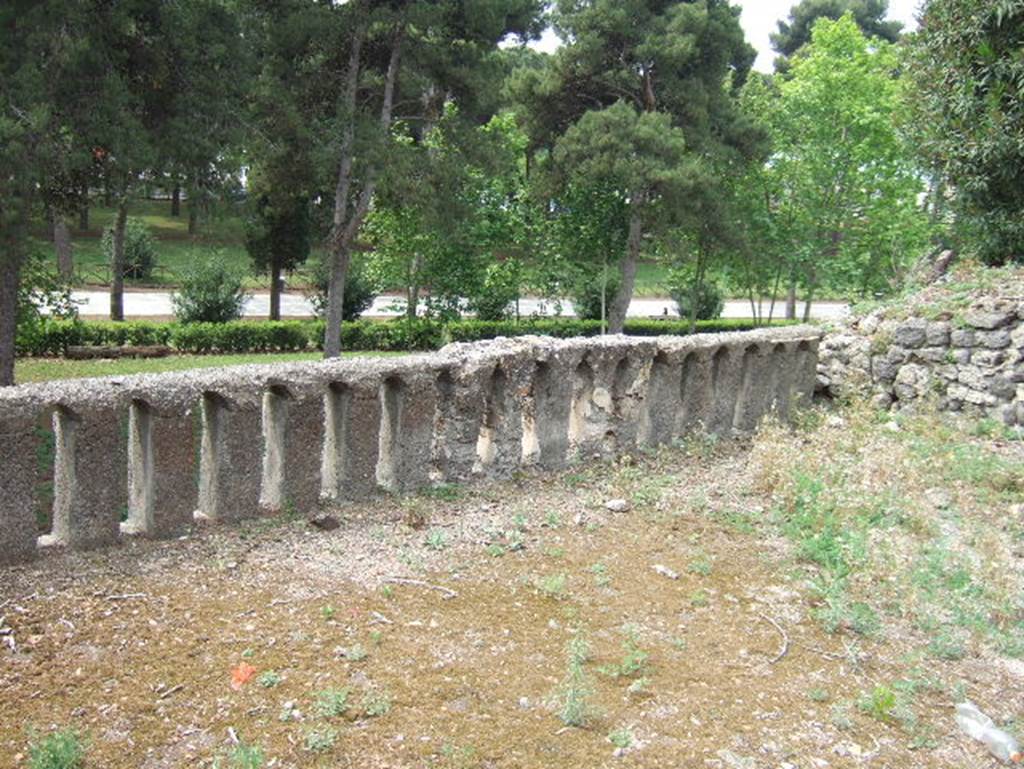 VIII.2.34 Pompeii. May 2006. Looking south-west across terrace ‘12’. Acording to Jashemski, Sogliano said the terrace on the lower level was probably enclosed by a low masonry wall. This wall would have contained a space for plants (a view not accepted by Mau), but only the part on the east was preserved.  It was covered with plaster and decorated with a Nile scene which was badly damaged. A crocodile pursued by a pigmy armed with a shield and lance, and also a pigmy woman with a basket, near to which stood a hippopotamus, could be seen. See Sogliano, N.Sc., 1885, p.257
See Jashemski, W. F., 1993. The Gardens of Pompeii, Volume II: Appendices. New York: Caratzas. (p. 209)
