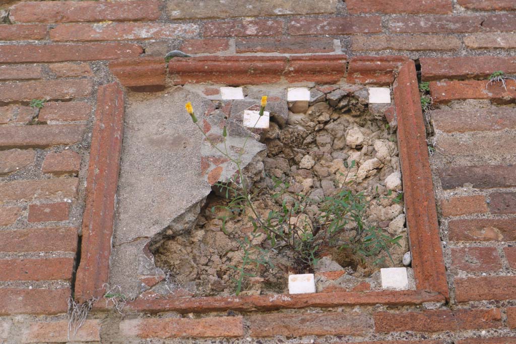 VIII.3.6 Pompeii, on left, and VIII.3.5, on right. December 2018. 
Detail of plaque on pilaster between doorways. Photo courtesy of Aude Durand.

