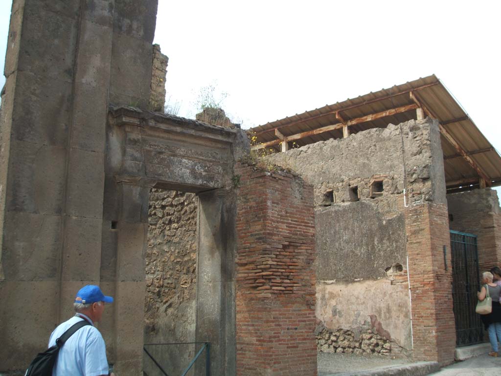 VIII.3.10 and VIII.3.9 Pompeii. May 2005.
According to Della Corte, this house on the north-east corner of the insula was another dependence of the house of Coeli.
It preserved intact its ancient facade in large blocks of Nocera tufa, with the steps in number 10 leading to the upper floor.
He said he thought that there did not seem to be any doubt that in 79AD, this was the house of another Medicus.
He thought the upper floor was a clinic.
A painted graffito that was visible on the architrave of tufa as a faint trace until 1817 showed the name of the medico. [CIL IV 9934].
See Della Corte, M., 1965. Case ed Abitanti di Pompei. Napoli: Fausto Fiorentino. (p.230, VIII.3.10-12)

According to Epigraphik-Datenbank Clauss/Slaby (See www.manfredclauss.de) this reads as -

A(ulus)  Pumponius 
Magonianus      [CIL IV 9934]
