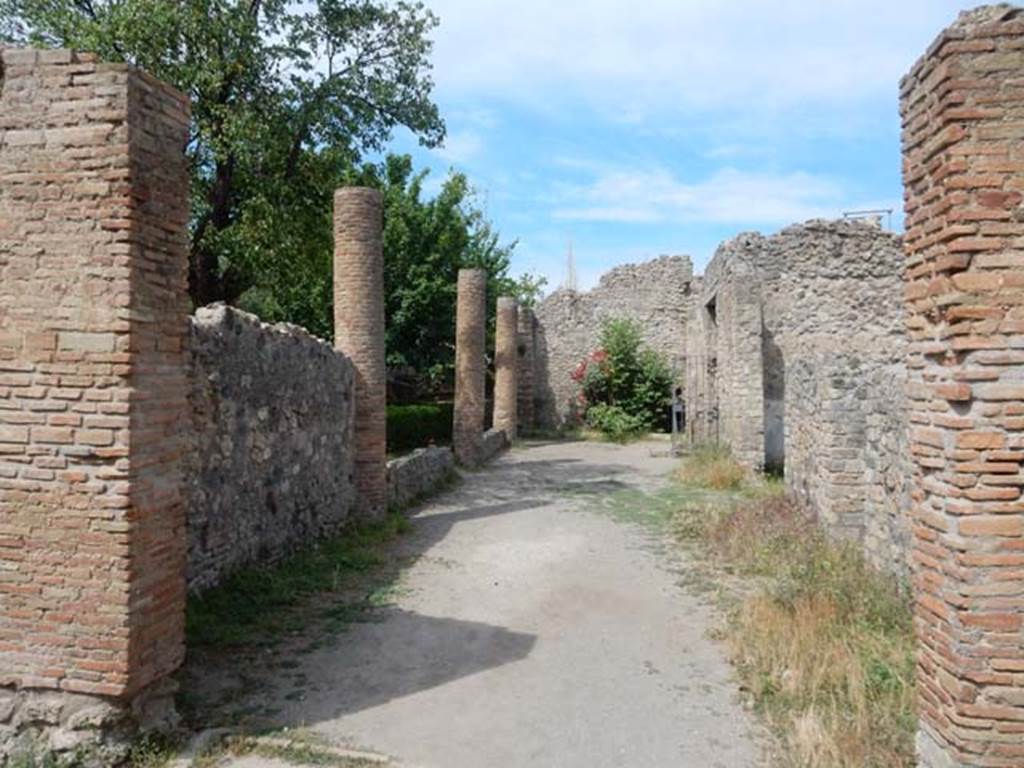 VIII.5.16 Pompeii. May 2017. Looking west from room 5, along north portico towards entrance doorway. Photo courtesy of Buzz Ferebee.
