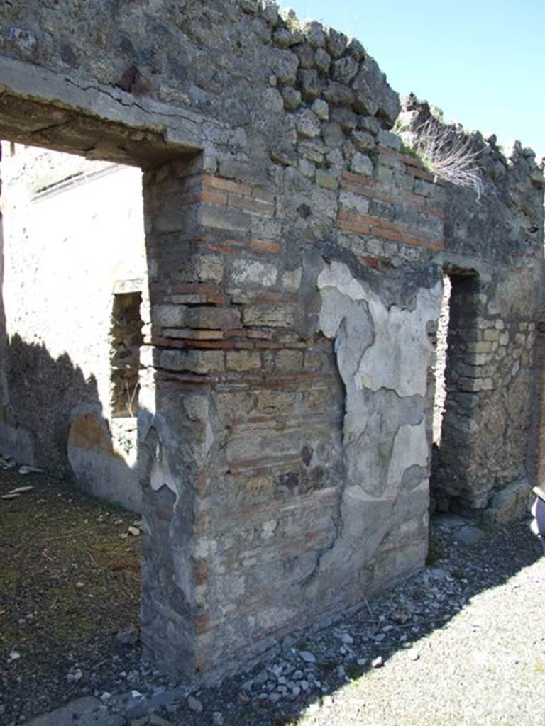 VIII.5.39 Pompeii. March 2009.  Wall of Room 1 with remains of plaster, between Rooms 5 and 6.