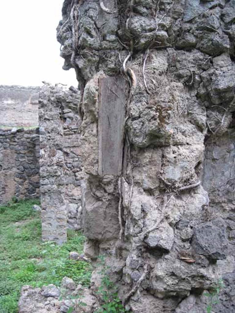 VIII.7.6 Pompeii. September 2010.  Remains of feature of downpipe. Looking north across east side of portico. Photo courtesy of Drew Baker.
