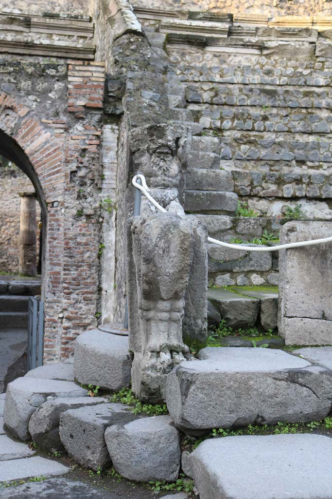 VIII.7.19 Pompeii. December 2018. 
Statue of Kneeling Atlas, with a tufa Lion’s foot in front, on west side near exit/entrance.
Photo courtesy of Aude Durand.
