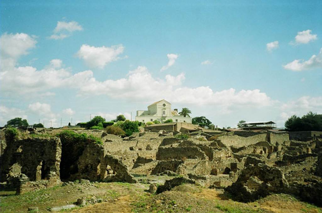 VIII.7.26 Pompeii. July 2010. Looking north-east from Large Theatre, overlooking the large rear garden. Photo courtesy of Rick Bauer. According to Jashemski, the triclinium on the north would have had a good view of the garden. In this photo, the triclinium would be the dark shaded room, on the left. See Jashemski, W. F., 1993. The Gardens of Pompeii, Volume II: Appendices. New York: Caratzas. (p. 222)