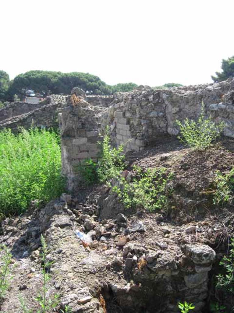 VIII.7.26 Pompeii. September 2010. Looking south, showing relationship of room to theatre pillar. Photo courtesy of Drew Baker.
