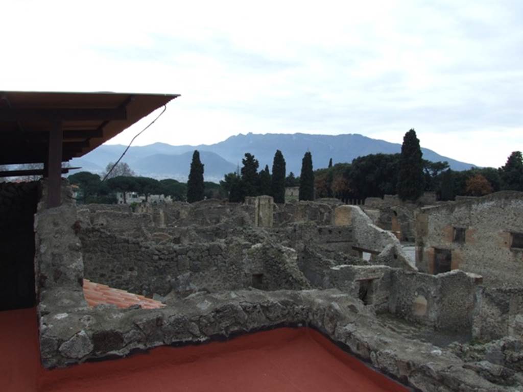 IX.1.20 Pompeii.  December 2007.  Room 16.  View from upper floor.
Looking south west towards the corner of IX.1.15/16 and the wall of the Stabian Baths on Via Stabia, on the right.
