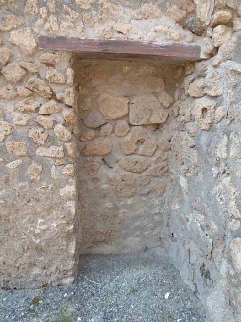 IX.1.24 Pompeii. May 2010. Blocked doorway or niche in north-west corner of shop.