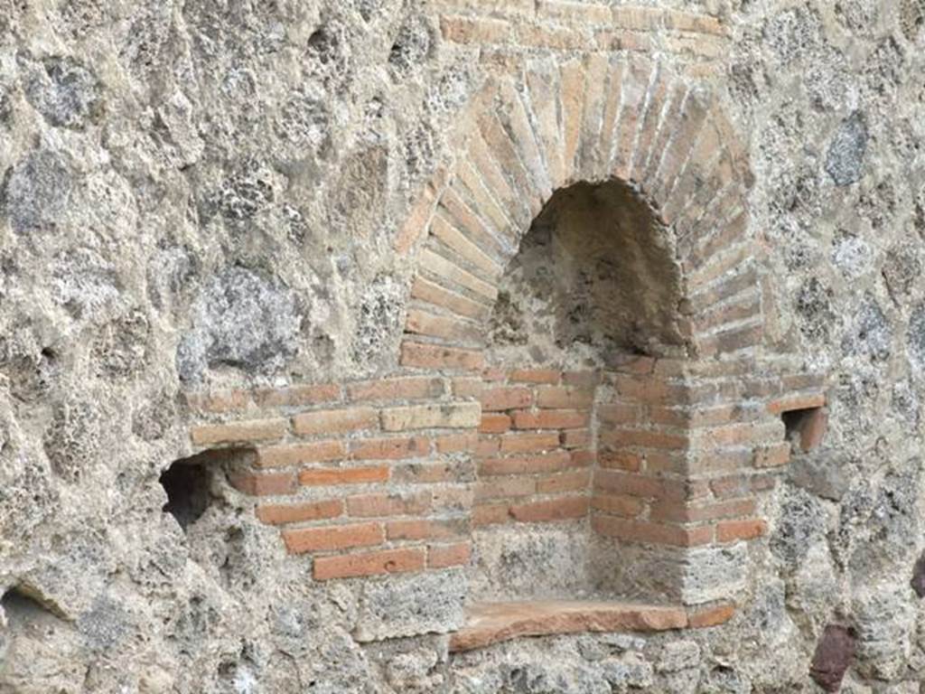 IX.5.6 Pompeii. December 2007. Room u, niche on east wall in garden area.  
According to Boyce, Mau measured this arched niche as h.0.31, w.0.39, d.019.
In 1937 Boyce said the niche measured h.0.70, w.0.60, d.0.20.
He felt that such a discrepancy could not be explained by the falling away of the coating of plaster which had left the bricks quite bare.
In front of the niche stood a small masonry altar.
He gave the references – Not. Scavi, 1878, 262; Bull. Inst., 1879, 94; Overbeck-Mau, 290.
See Boyce G. K., 1937. Corpus of the Lararia of Pompeii. Rome: MAAR 14. (p.85, no. 422) 

