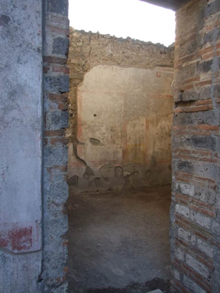 IX.5.11 Pompeii. December 2007. Doorway to room 6, oecus with a window overlooking the garden, looking south-west. The walls of this room were decorated in the IVth Style.
The zoccolo was divided into panels, the middle zone was divided into compartments with a white background, and the upper zone also had a white background. This room was decorated with images of the Muses, beginning from the east wall, of 
Clio, who reads from an open volume held between her hands,
Talia, with comic mask and shepherds crook,
Urania, with globe and pen (stilo),
Euterpe, with two long pan-pipes,
Melpomene with tragic mask and club,
Erato in attitude of playing the lyre,
Tersicore, playing the zither,
And finally Polimnia wrapped in her cloak.
In this room, a burnt human skeleton was found, with a gold ring on the finger.
See NdS, 1877, (p.250)
