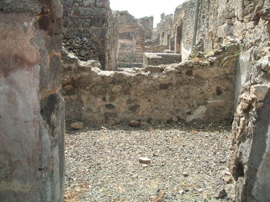 IX.6.3 Pompeii. May 2005. Looking south across room “h” (into rear of IX.6.b), on south side of atrium. According to Mau, this room was found with a wooden threshold and white plaster on its walls. Seen on the extreme left of the rear wall, was the usual recess for the short side of the bed which would have been against the left wall.  In fact, in this part, the rough floor was a little better preserved.
