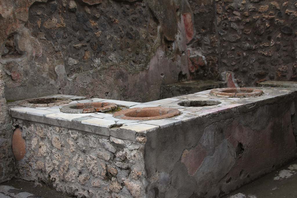 IX.7.13 Pompeii. April 2014. Looking towards north-west corner across podium/counter with inset dolia. Photo courtesy of Klaus Heese.